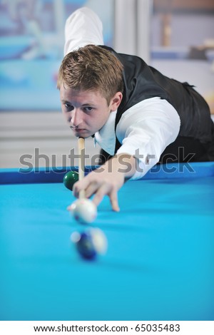 young pro billiard player finding best solution and right angle at billard or snooker pool sport  game