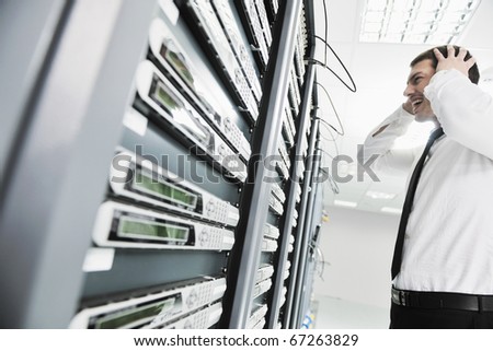 business man in network server room have problems and looking for  disaster solution