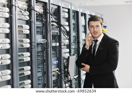young handsome business man it  engeneer in datacenter server room