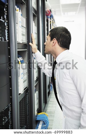 young handsome business man it  engineer in data center server room