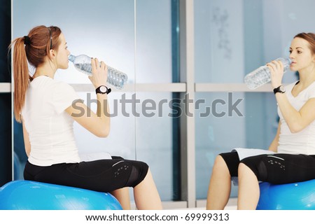 young woman drink water at fitness workout training at sport club