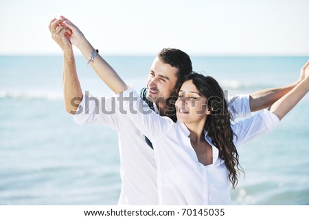happy young couple in white clothing  have romantic recreation and fun at beautiful beach on  vacations