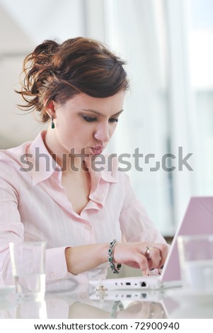 happy young business woman working on laptop computer at  group team meeting at modern office