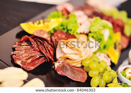 buffed food closeup of  fruits, vegetables, meat and fish arranged on banquet table