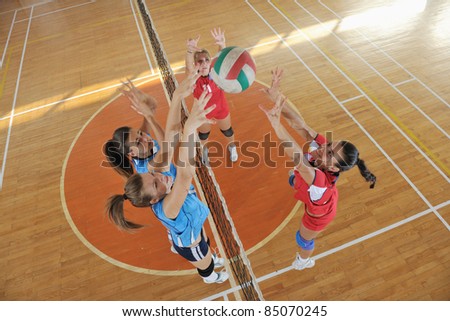 volleyball game sport with group of young beautiful  girls indoor in sport arena