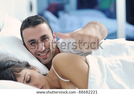 happy young healthy people  couple have good time in their bedroom make love and sleep