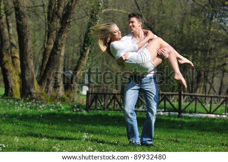 happy young romantic couple in love dance outdoor at spring season on early mornig with beautiful light
