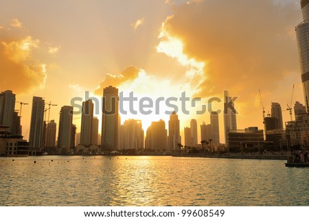 dubai city skyline at sunset conctruction and modern architecture concept