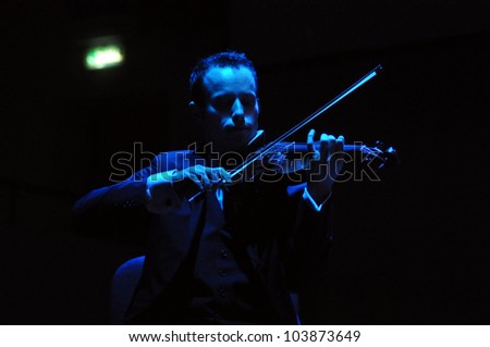 CLUJ NAPOCA, ROMANIA Ã¢Â?Â? MAY 29: Nicholas Crosa from Pink Martini pop-jazz band performs live on violin at the Sports Hall of Cluj, Romania, MAY 29, 2012 in Cluj-Napoca, Romania