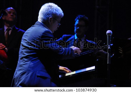 CLUJ NAPOCA, ROMANIA Ã¢Â?Â? MAY 29: Thomas Lauderdale from Pink Martini pop-jazz band performs live on piano at the Sports Hall of Cluj, Romania, MAY 29, 2012 in Cluj-Napoca, Romania