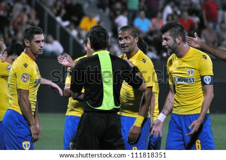CLUJ-NAPOCA, ROMANIA - SEPTEMBER 2: Players of Petrolul Ploiesti (in yellow) protesting against referee at a Romanian soccer game against CFR Cluj, final score 2-2, Sept. 2, 2012 in Cluj, Romania