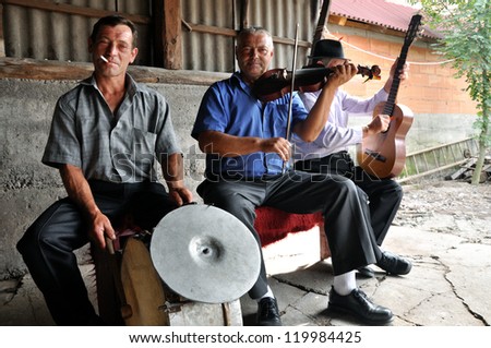 IEUD, ROMANIA- AUGUST 10: Musicians at a celebration of a traditional Romanian wedding in traditional dresses at the Ieud Village Festival Days, at  Aug 10, 2012, in  Ieud, Maramures, Romania