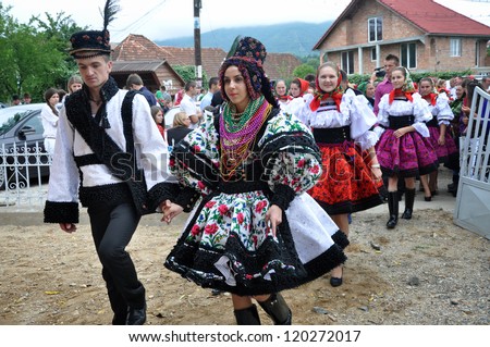 GHERTA MICA, ROMANIA - JULY 12: Unidentified villagers in traditional dresses celebrate a traditional Romanian wedding on JULY 12, 2012, in Gherta Mica, Maramures, Romania.