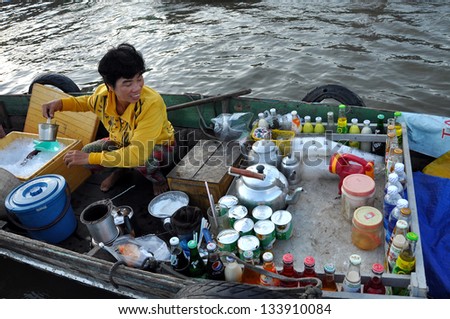 CAN THO - FEB 17: Unidentified woman selling goods at the Floating Market in Can Tho, Vietnam on Feb 17, 2013. With hundreds of boats, Cai Rang is the biggest floating market in the Mekong Delta