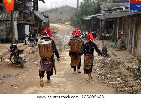 TA PHIN - FEB 24: A group of unidentified Red Dzao indigenous women selling their goods in the village. Red Dzao tribe is one of the minority tribes in the area. On Feb 24, 2013, Sa Pa, Vietnam