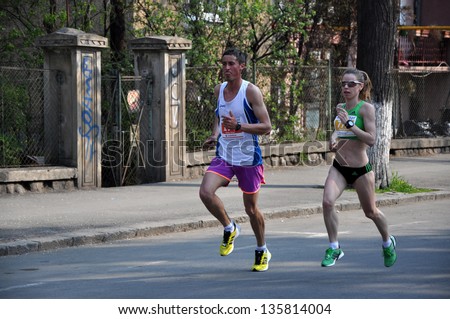 CLUJ NAPOCA - APRIL 21: Unidentified participants at the Cluj International Marathon running through the city of Cluj Napoca, on April 21, 2013 in Cluj Napoca, Romania
