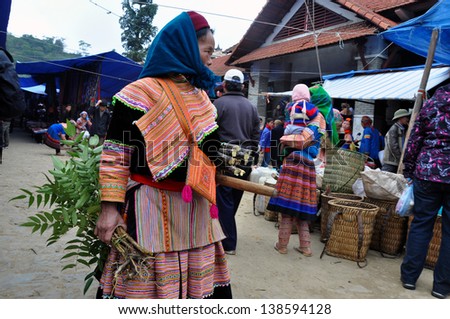 BAC HA - FEB 23: Unidentified woman selling herbs in Bac Ha market. The market is a must see destination for every traveler in Vietnam. On Feb 23, 2013 in Bac Ha, Sa Pa, Vietnam