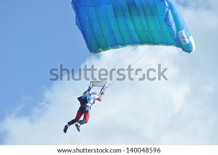 CLUJ NAPOCA, ROMANIA - MAY 18: Parachutists from the Romanian Aeroclub Team and the Romanian Air Force Army jumping on the Romanian Air Fest on May 18, 2013 in Cluj Napoca, Romania