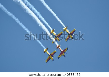 CLUJ NAPOCA, ROMANIA - MAY 18: A group of aircraft in flight smoke color at the Romanian Military Parade on May 18, 2013 in Cluj Napoca, Romania