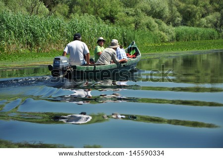 SULINA - JUNE 25:Unidentified people take boat trip with a local ranger in the Danube Delta Biosphere Reserve. Danube delta is the second largest river delta in Europe. On June 25 in Sulina,Romania