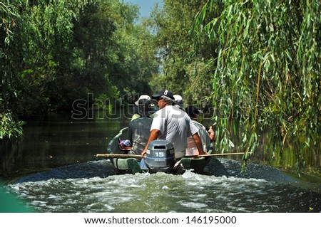 SULINA - JUNE 25:Unidentified tourists take boat trip with a local guide in the Danube Delta Biosphere Reserve. Danube delta is the second largest river delta in Europe. On June 25 in Sulina,Romania