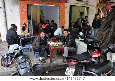 HANOI - FEB 19: Unidentified Vietnamese men drinking local beer called Bia Hoi in Hanoi. The beer is brewed daily and each bar gets a fresh batch every day. On Feb. 19, 2013 in Hanoi, Vietnam