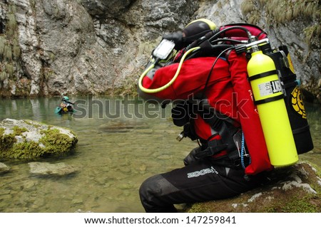 ARIES - CIRCA JUNE 2009: A cave diver emerges from the Tauz spring, after exploring the cave. Cave diving is a very dangerous sport and means of exploration and research circa June 2009 in Aries, Romania
