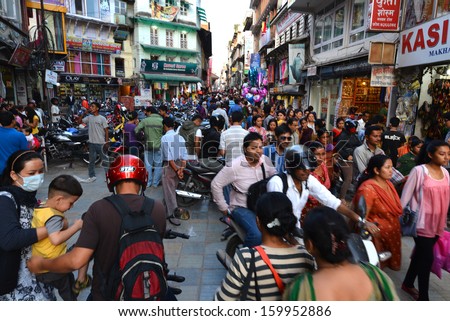 KATHMANDU, NEPAL - SEPTEMBBER 28: Crowd of local Nepalese people on the streets during the Dashain festival in Kathmandu on Sept 28, 2013 in Kathmandu, Nepal.