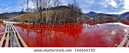 Environmental disaster. Panorama of a lake full with contaminated water from a mine in Geamana, Rosia Montana, Romania