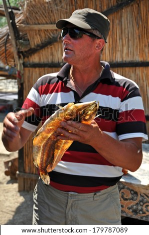 DANUBE DELTA, ROMANIA - JUNE 25: Unidentified local fisherman in the Danube delta. Fishing is a necessity for local people for the everyday food. On June 25, 2013, in Sulina, Romania