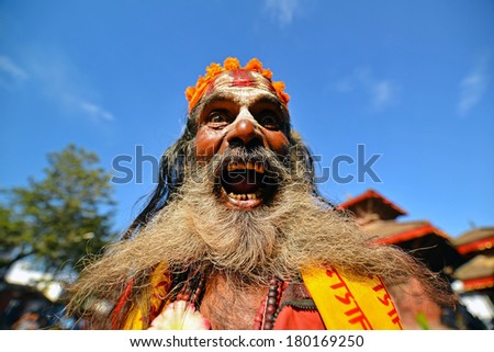 KATHMANDU, NEPAL - OCTOBER 8: Holy Sadhu man with long beard and traditional painted face at the Durbar square. On October 8, 2013 in Kathmandu, Nepal
