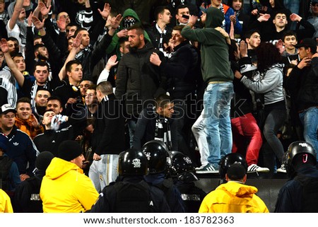 CLUJ - MARCH 4: Stewards trying to stop the hooligans of the U Cluj soccer team to run on the field during a match against CFR Cluj. Final score: CFR - U Cluj: 1:2. On March 4, 2014 in Cluj, Romania