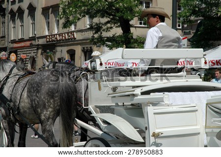 KRAKOW, POLAND - MAY 29: Horse carriages waiting for tourists in Krakow. Taking a horse ride in a carriage is very popular among tourists visiting Krakow. On May 29, 2005 in Krakow, Poland