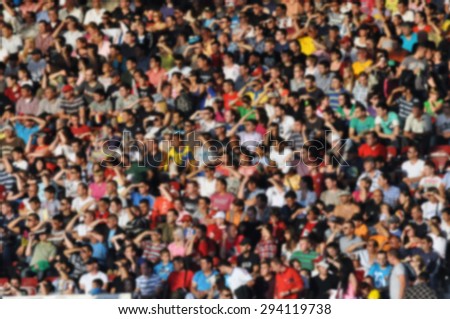 Crowd of people at a soccer match - blurred image