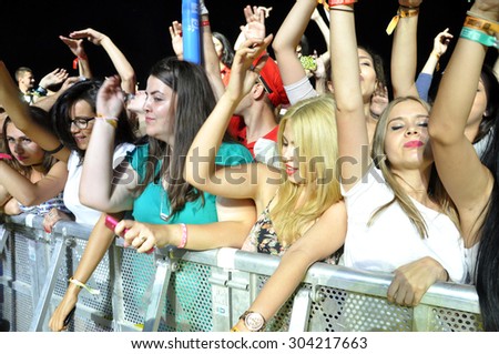 CLUJ NAPOCA, ROMANIA - JULY 30, 2015: Crowd of cheerful young people having fun\
 during a live concert at Untold Festival in the European Youth Capital city of Cluj Napoca