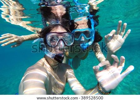 Similar – Image, Stock Photo Young man with snorkel and diving mask swimming and taking a selfie under water. Travel, vacation and sports activity concept.