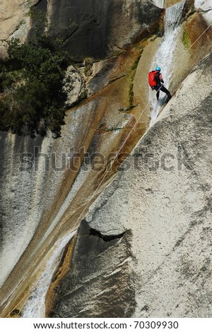 PURCARACCIA CANYON, CORSICA - AUGUST 28: An extreme sports team member participating  in a canyoning contest on the famous waterfalls of Purcaraccia valley, on August 28, 2010 in Corsica, France