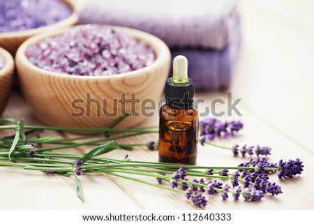 aromatherapy oil andbowl of lavender bath salt - beauty treatment
