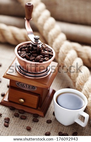 cup of coffee with coffee grinder - coffee time