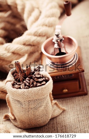 coffee grinder with coffee beans in sack - coffee time