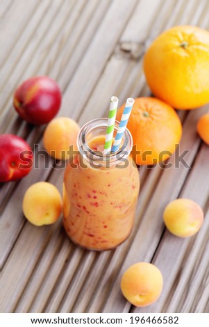bottle of orange fruity smoothie - food and drink