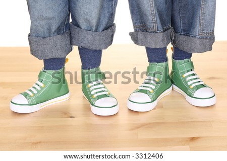 four children legs in sneakers on the floor