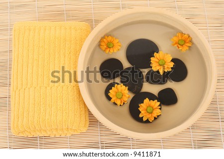 bowl of water with stones and towel