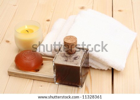 glycerin soap bottle of massage oil and towels