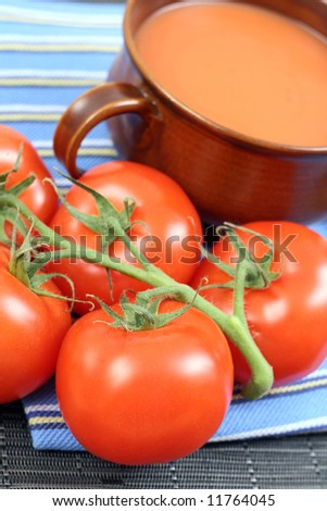 bowl of fresh tomato soup and fresh tomatoes