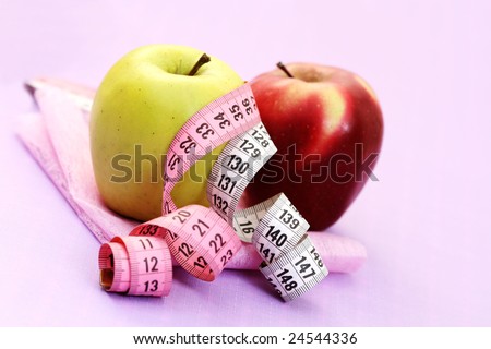 red and green apple with tape measure - healthy food