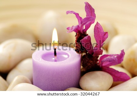 candle and lavender flowers in stones - relaxing time