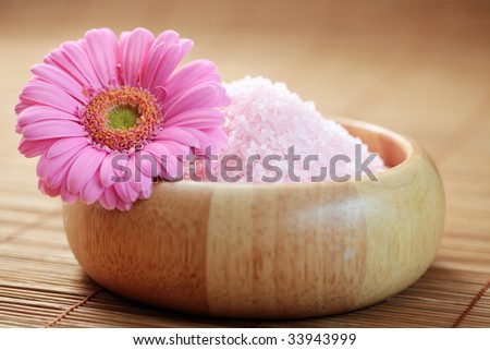 bowl of pink bath salt with flower - beauty treatment