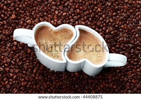 2 cups of coffee shape of heart and coffee beans - coffee time