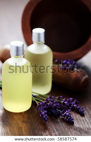 bottle of lavender massage oil with mortar and pestle - beauty treatment